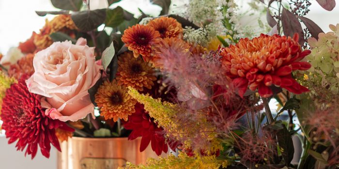 Fall centerpiece using grocery store flowers and copper canisters.