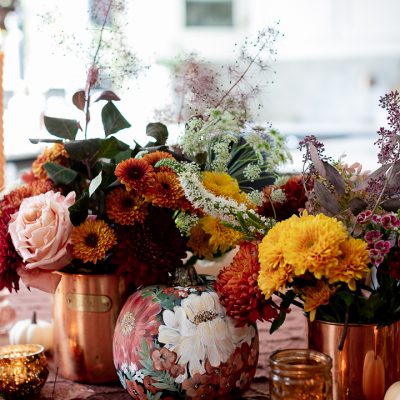 Fall centerpiece using grocery store flowers and copper canisters.