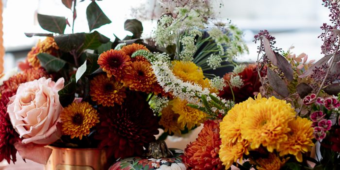 Fall centerpiece using grocery store flowers and copper canisters.